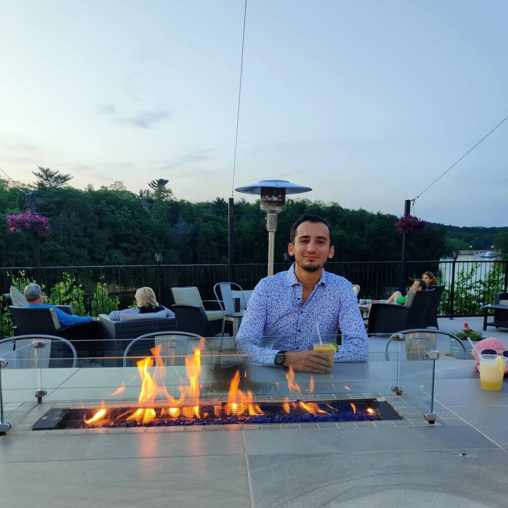 Man with drink at Riverfront Terrace