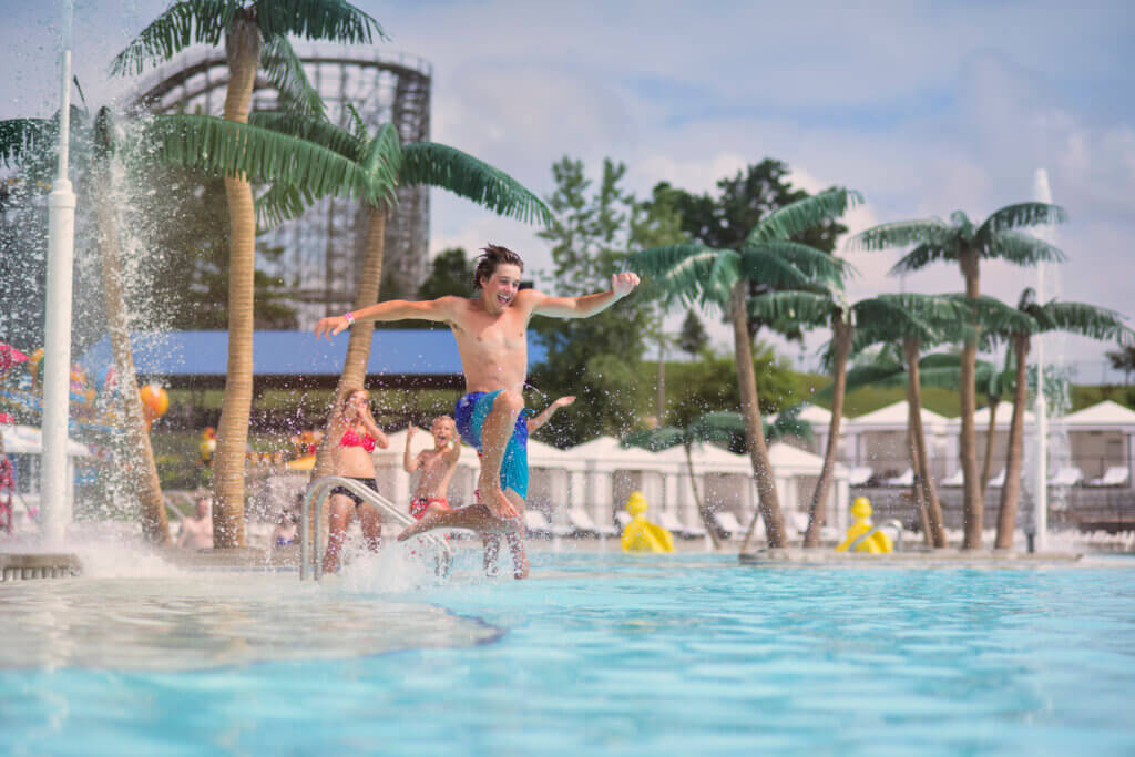 Boy jumping into pool at Mt. Olympus