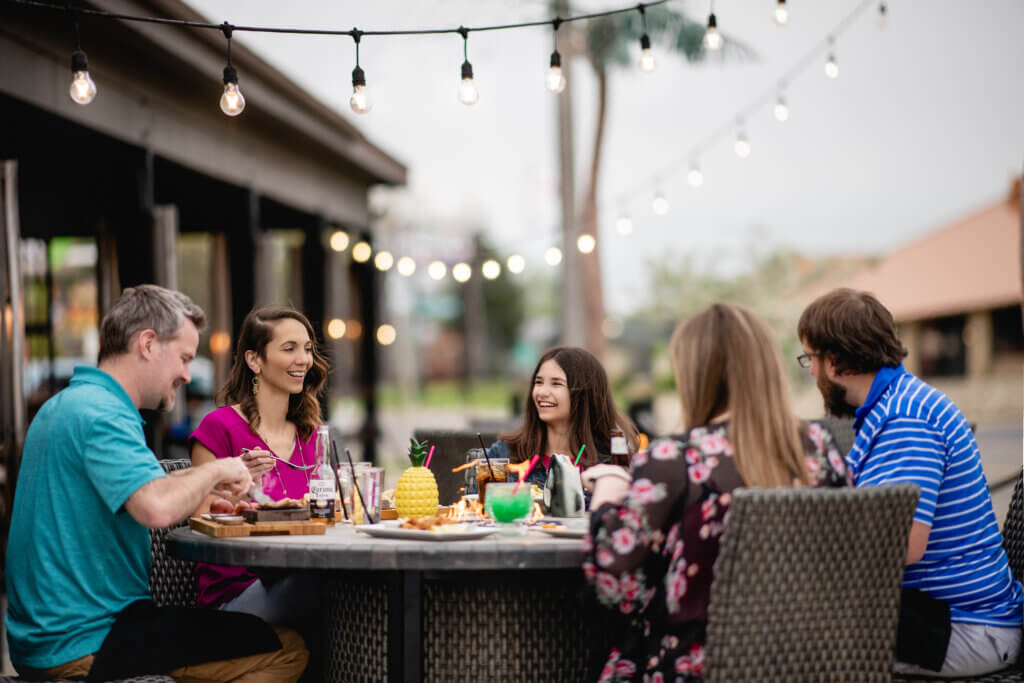 Family on outdoor patio at Hot Rocks