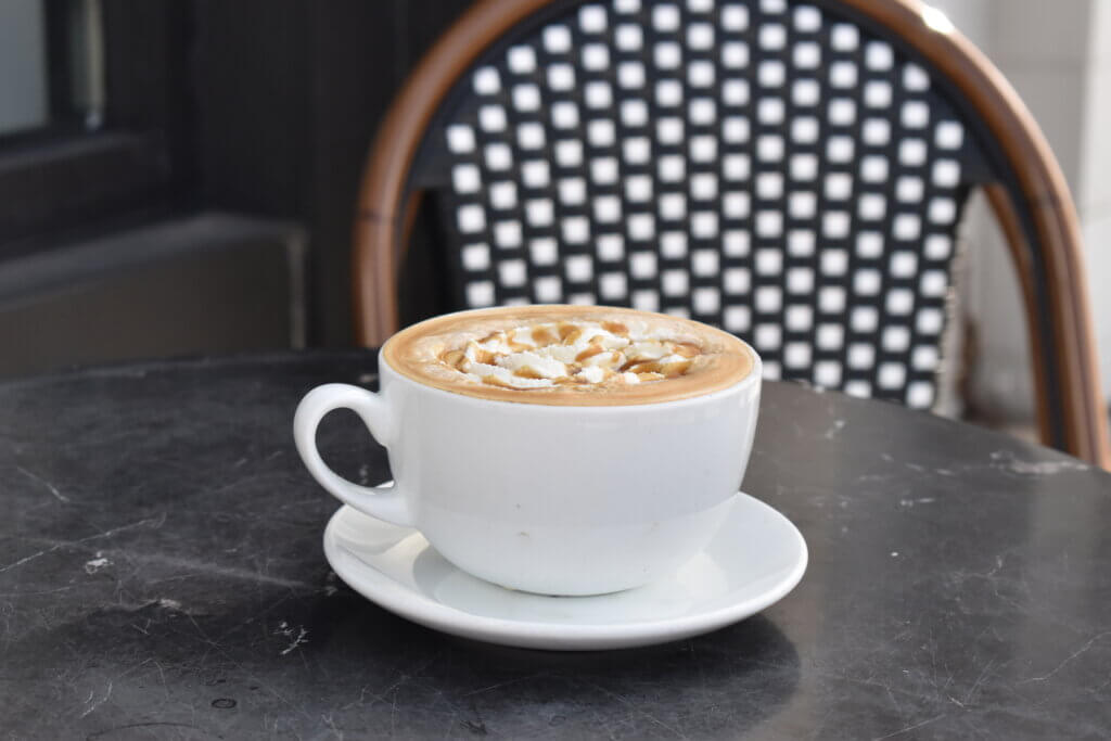 Bella Goose's Salted Caramel Latte on a black marble table