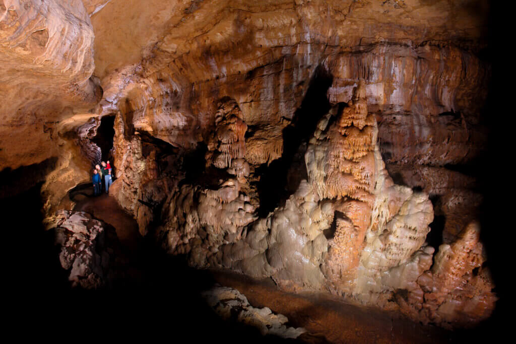 Family of four exploring underground cave walkways